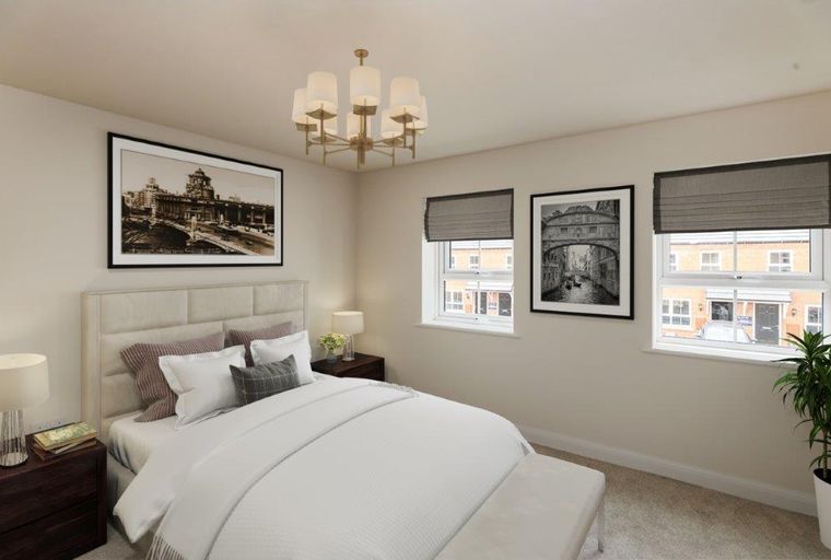 A bedroom with a bed, bedside tables, windows, and wall art.