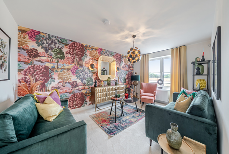 A living room with a colorful wallpaper, velvet sofas, and accent furniture.