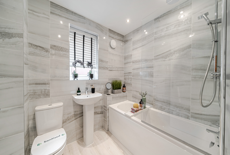 A bathroom with a toilet, sink, and bathtub.