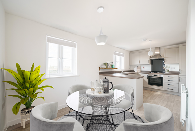A dining area and kitchen with a round table, chairs, and kitchen cabinets.