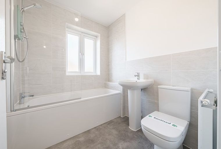 A bathroom with a bathtub, a sink, and a toilet.