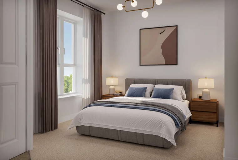 A bedroom with a bed, two nightstands, and a window.