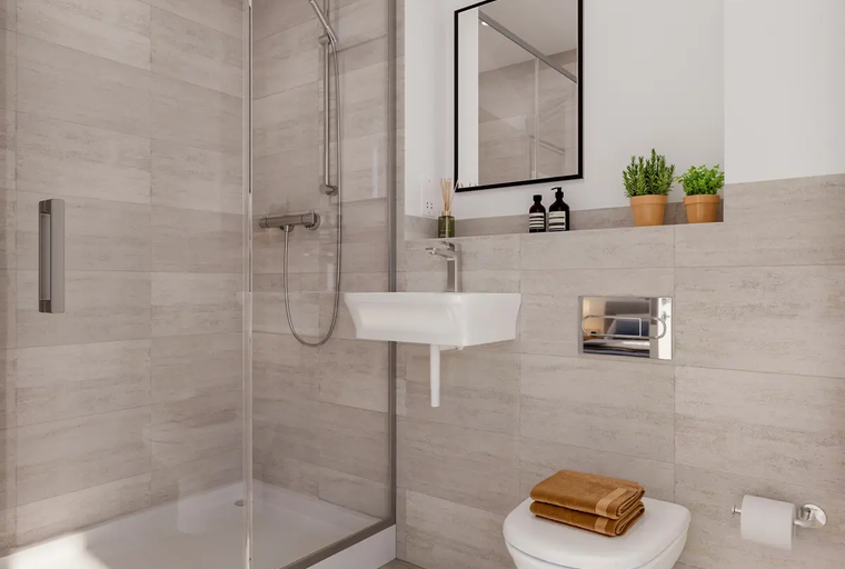 A bathroom with a shower, sink, and toilet.