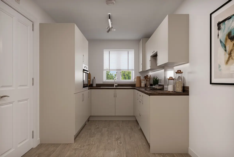 A U-shaped kitchen with white cabinets, dark countertops, and a window.