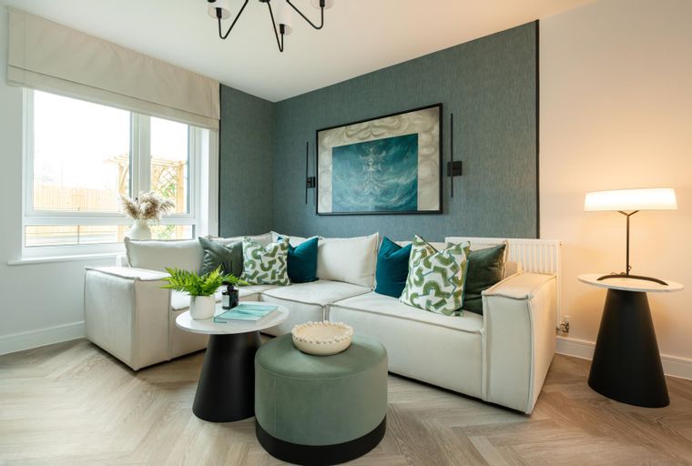 A living room with a sectional sofa, coffee tables, and a table lamp.