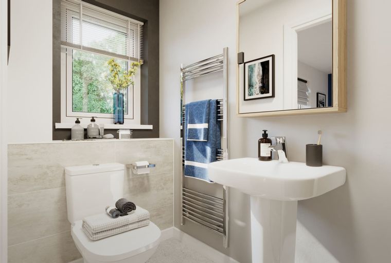 A bathroom with a toilet, sink, and a heated towel rail.