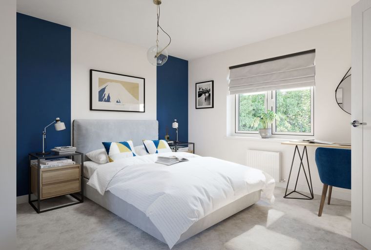 A bedroom with a bed, bedside tables, a desk, and a window.