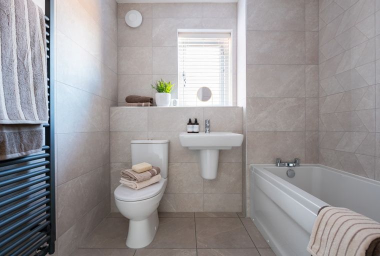 A bathroom with a bathtub, sink, and toilet.