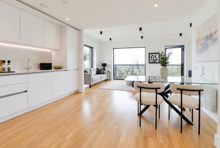 A modern apartment with a kitchen, living area, and dining space.