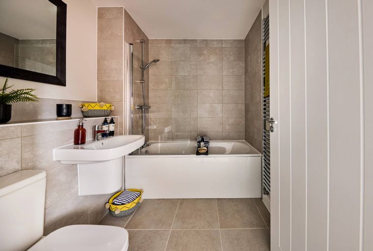 A bathroom with a bathtub, sink, and toilet.