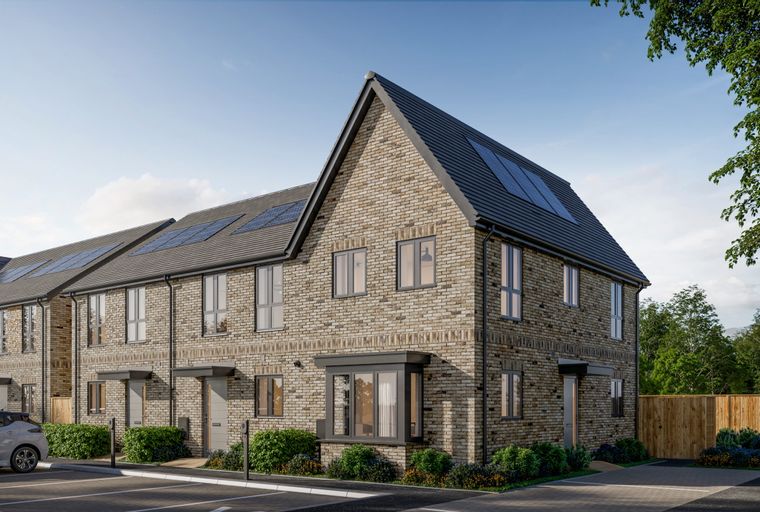 A row of modern brick townhouses with solar panels on the roof, parked cars, and landscaping.