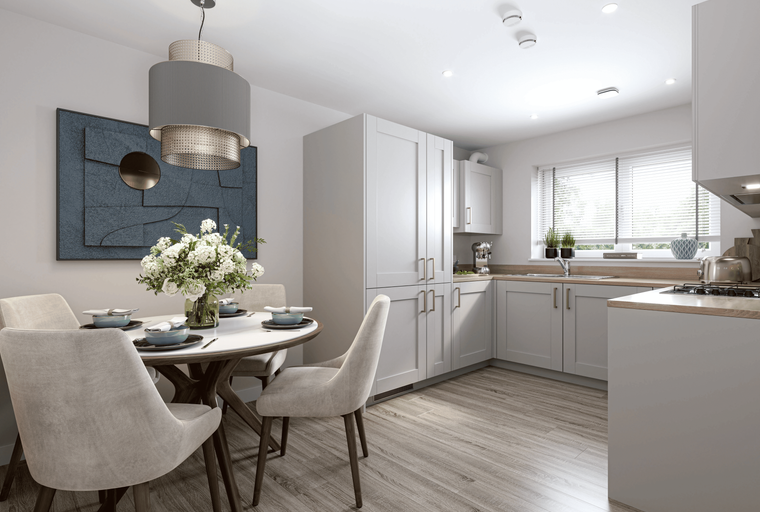 A kitchen and dining area with a round table, chairs, and light gray cabinets.