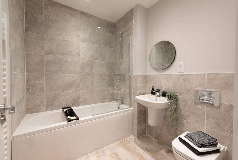 A bathroom with a bathtub, shower, sink, and toilet.