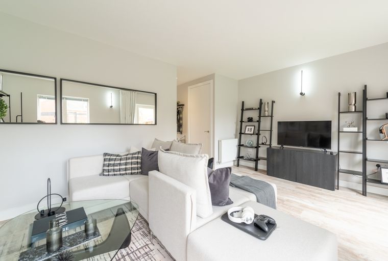 A living room with a sectional sofa, coffee table, and entertainment center.