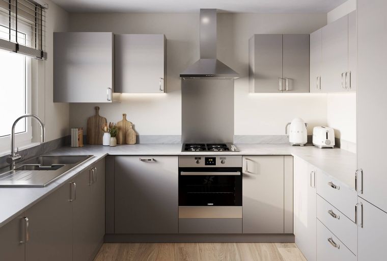 A modern U-shaped kitchen with grey cabinets, a stone countertop, and stainless steel appliances.