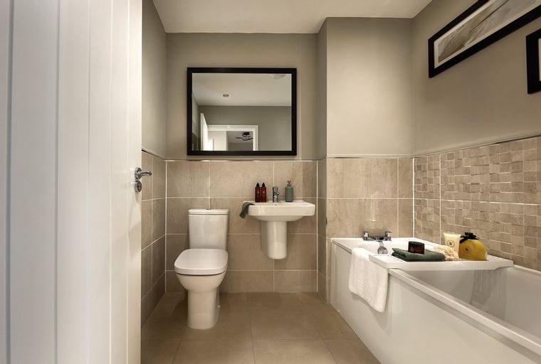 A bathroom with a toilet, sink, and bathtub.