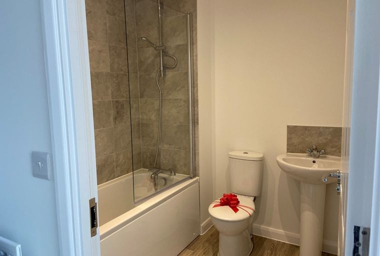 A bathroom with a bathtub, shower, toilet, and sink.