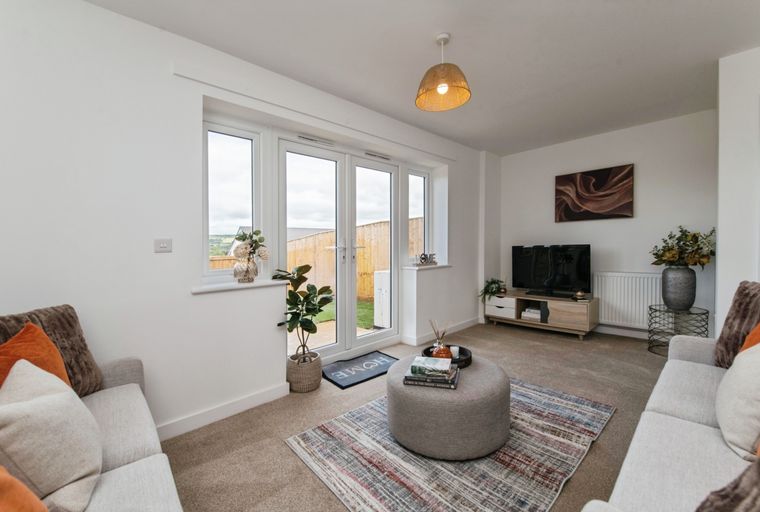 A living room with sofas, a coffee table, and a television.