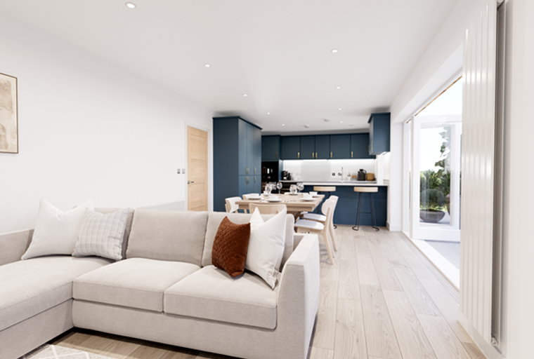 A living room and kitchen area with a sectional sofa, dining table, and navy blue cabinets.