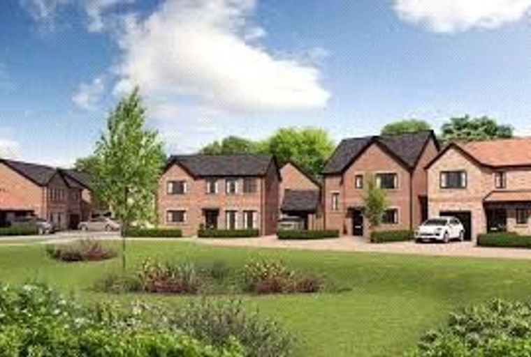 A row of modern brick houses with well-kept lawns and driveways.