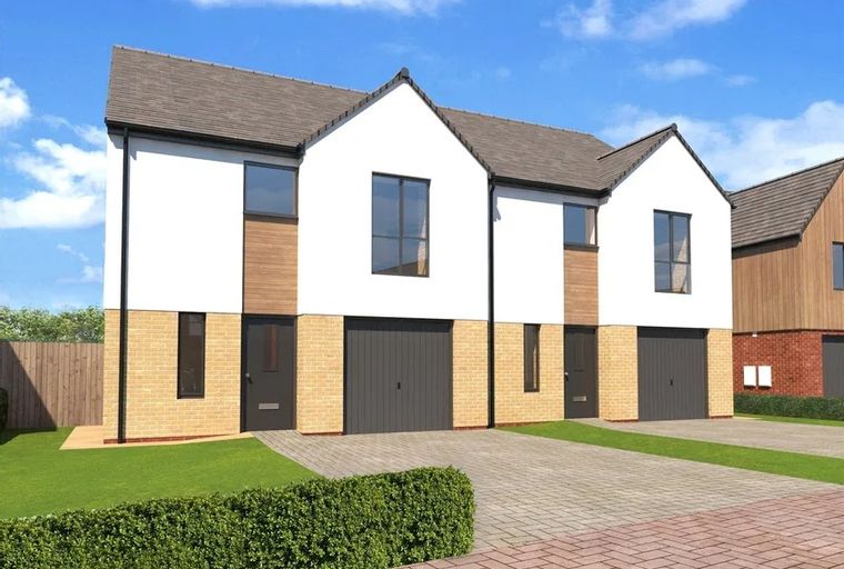 A modern semi-detached house with garages and front gardens.