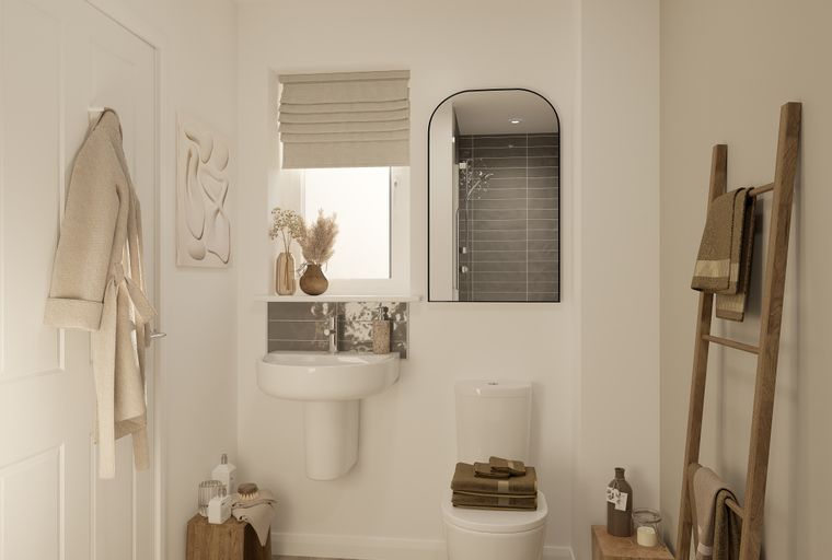 A bathroom with a sink, toilet, shower, and a ladder towel rack.