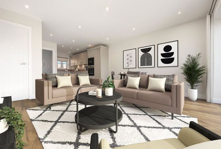A living room with two sofas, a coffee table, and artwork on the wall.