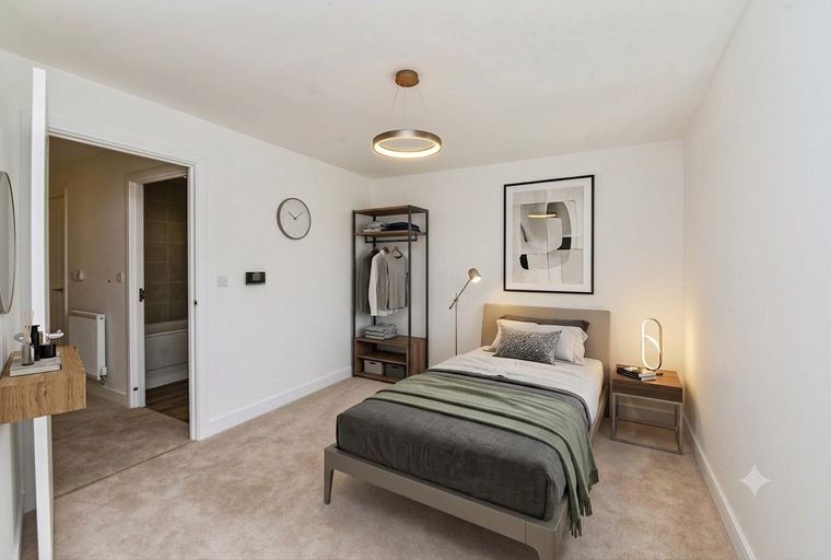 A bedroom with a single bed, a wardrobe, and a framed picture on the wall.