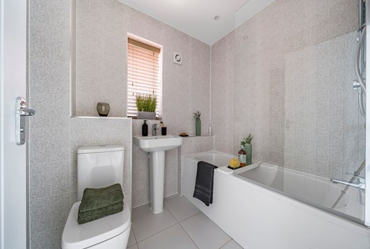 A bathroom with a toilet, sink, and bathtub.