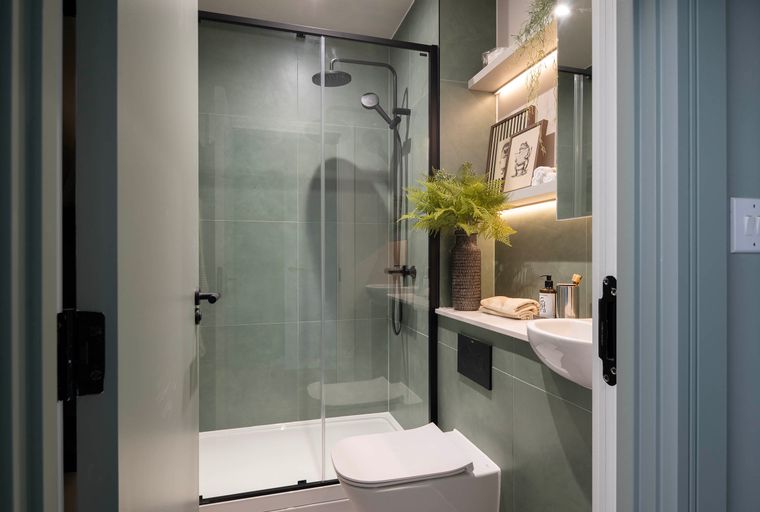 A bathroom with a shower, toilet, and sink.