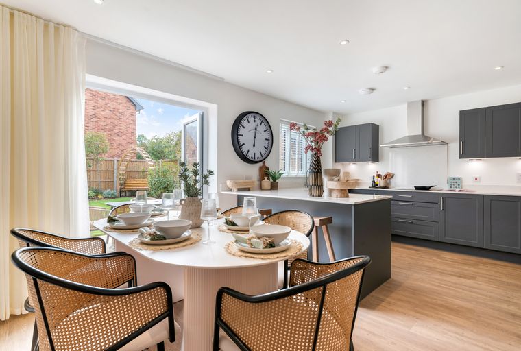 A dining area and kitchen with a table, chairs, and island.