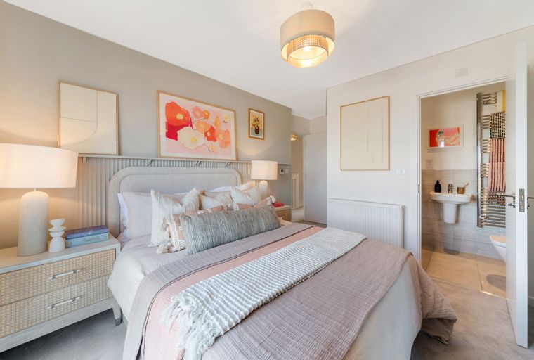 A bedroom with a bed, nightstand, and an en-suite bathroom.