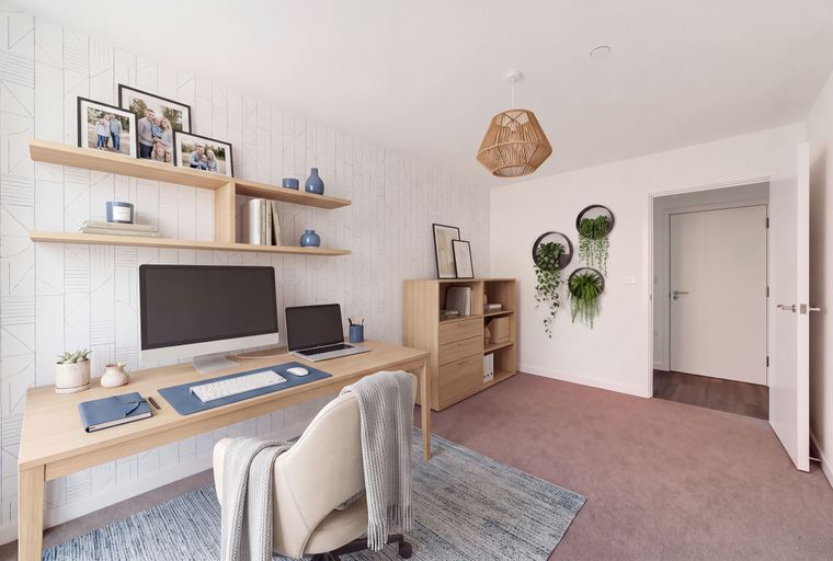 A home office with a desk, computer, laptop, shelves, and plants.