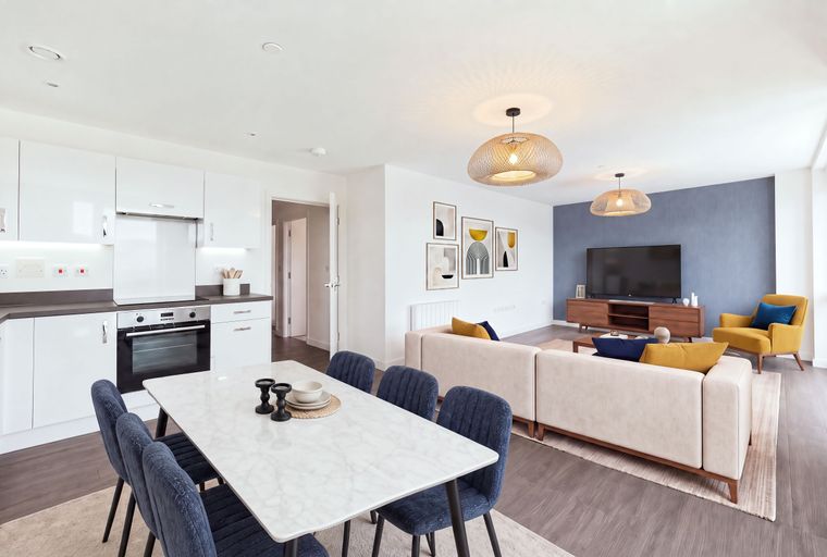 A dining area and living room with a sofa, chairs, and a television.