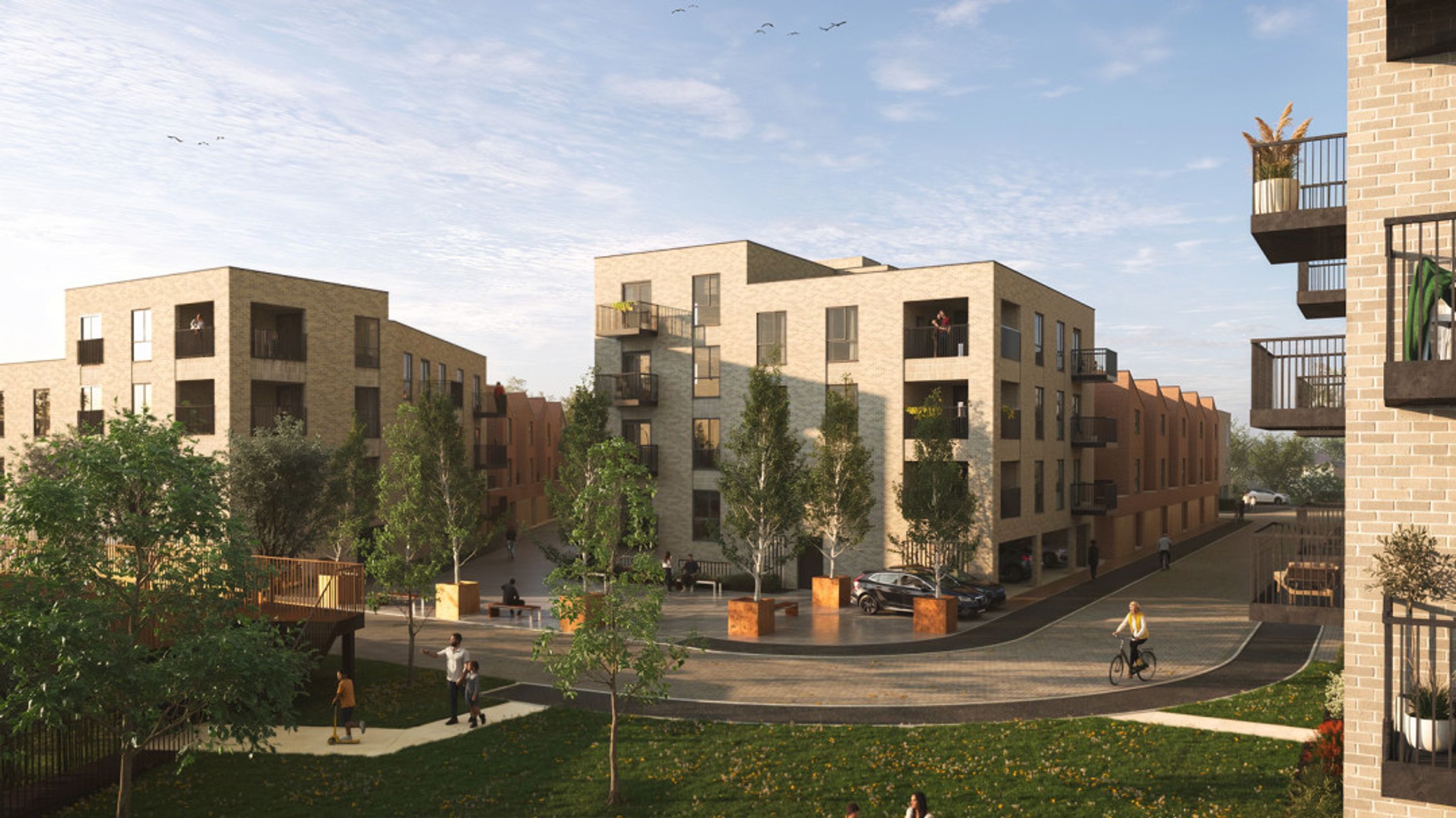 A street view of a modern apartment complex with balconies and trees.