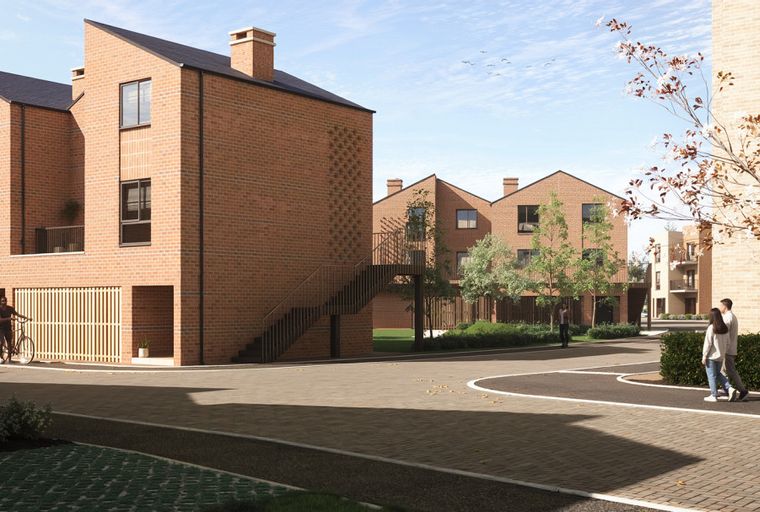 A street view of a modern housing development with brick townhouses, paved pathways, and trees.