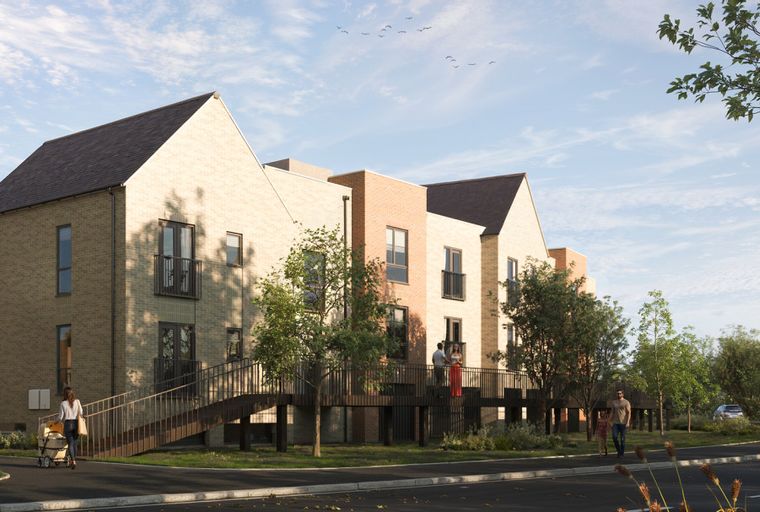 A row of modern brick townhouses with pitched roofs and balconies, connected by elevated walkways.