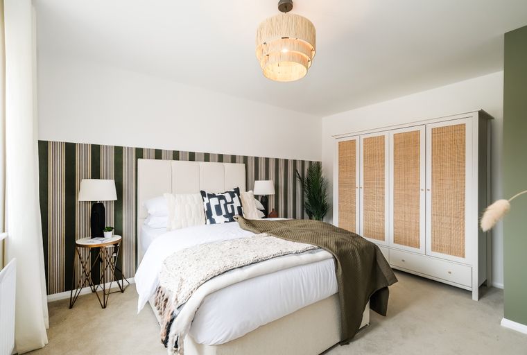 A bedroom with a bed, wardrobe, and a bedside table.