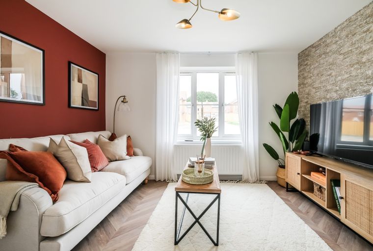 A living room with a sofa, coffee table, and television.