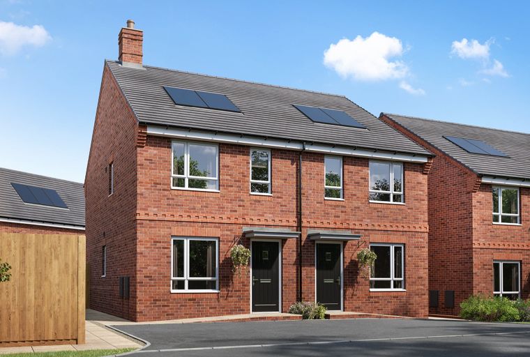 A row of red brick houses with grey tiled roofs and solar panels under a blue sky with clouds.