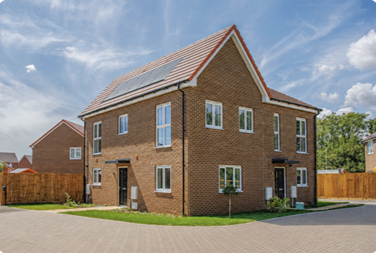 A modern brick semi-detached house with solar panels on the roof and a paved driveway.