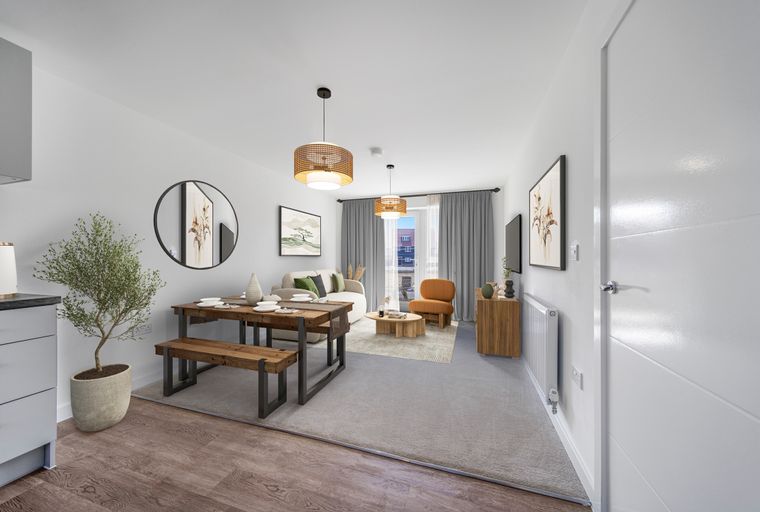 A dining area and living room with a wooden table, benches, sofa, and armchair.