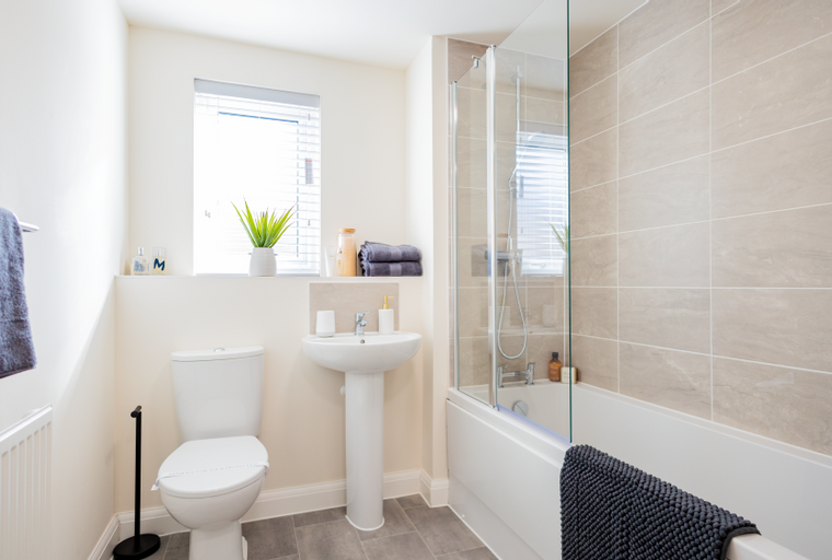 A bathroom with a toilet, sink, and bathtub.