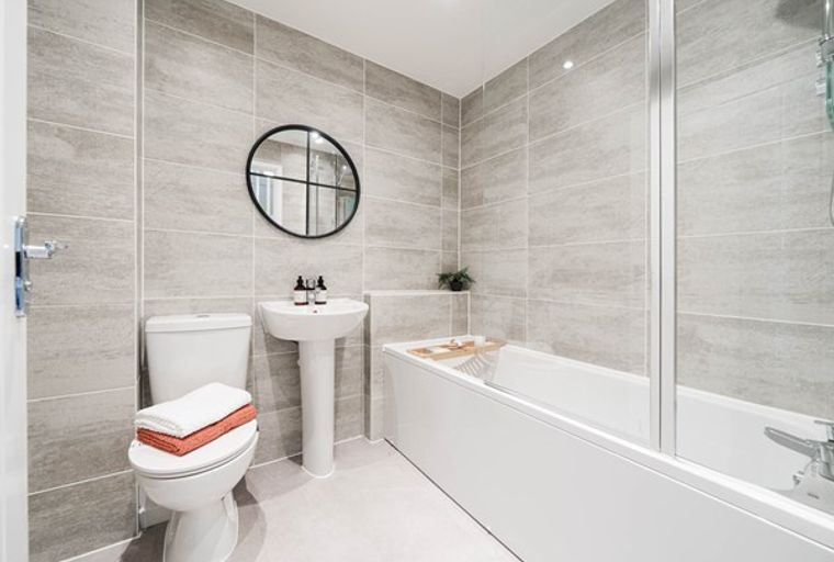 A bathroom with a toilet, sink, and bathtub.