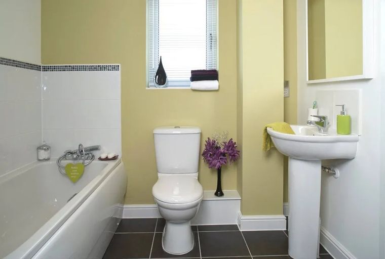 A bathroom with a bathtub, toilet, and sink.