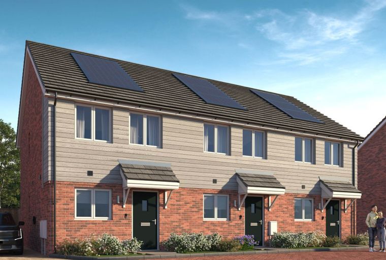 A row of modern townhouses with brick and siding exteriors, solar panels on the roof, and a couple standing outside.