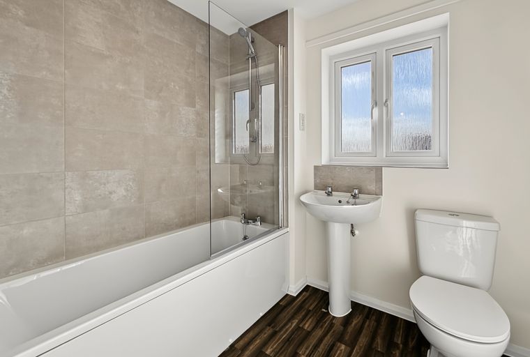 A bathroom with a bathtub, a sink, and a toilet.