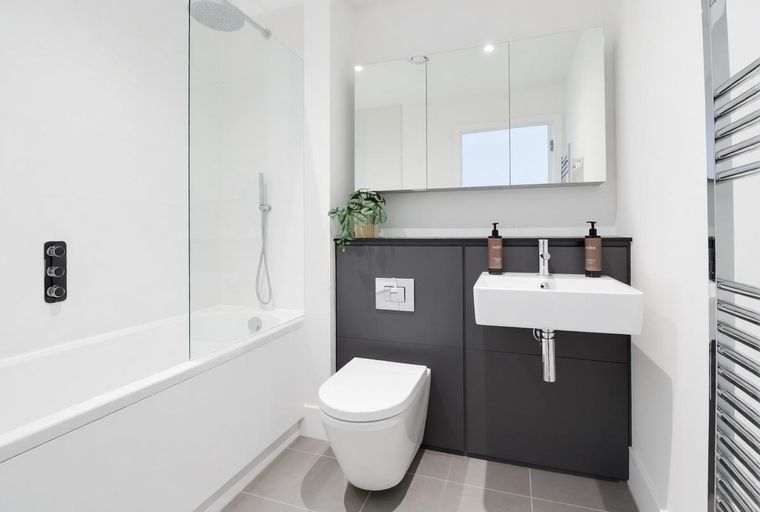 A bathroom with a bathtub, toilet, and sink.