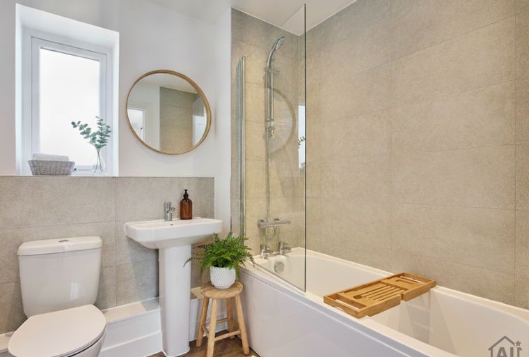 A bathroom with a toilet, sink, and bathtub.
