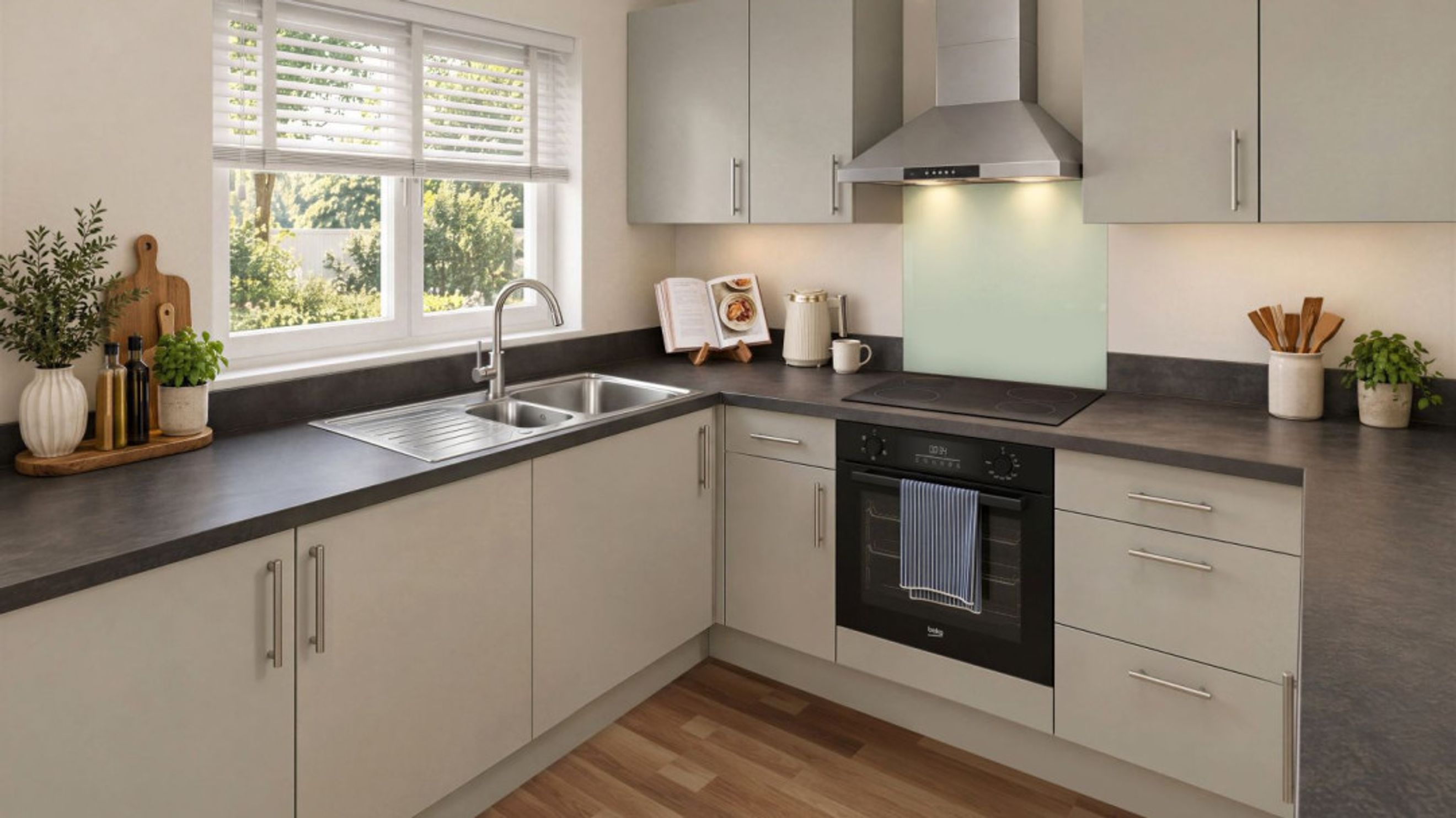 A modern kitchen with light-colored cabinets, dark countertops, a sink, and an oven.